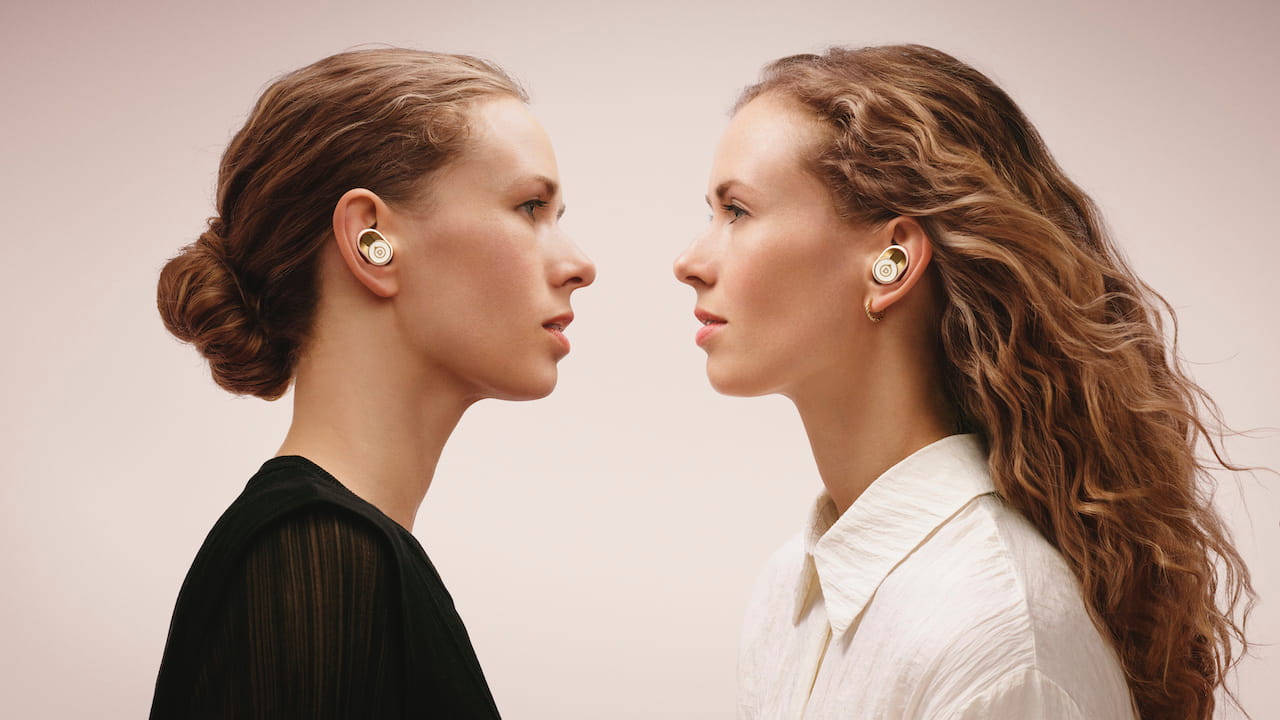 Women wearing Devialet Gemini II True Wireless Earbuds Opera de Paris Edition
