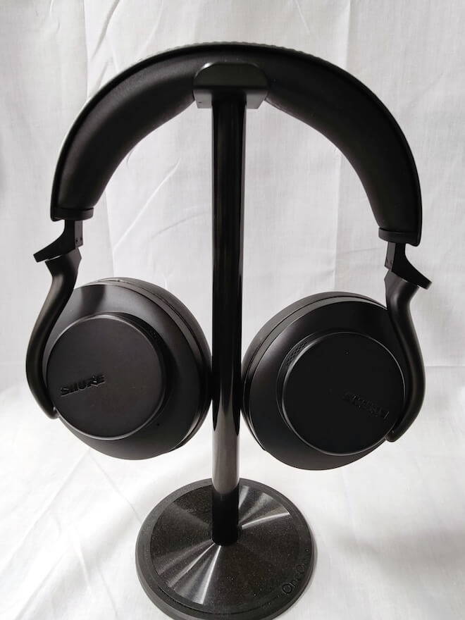 Shure AONIC 50 Wireless Noise Cancelling Headphones in Black on stand fold flat exterior