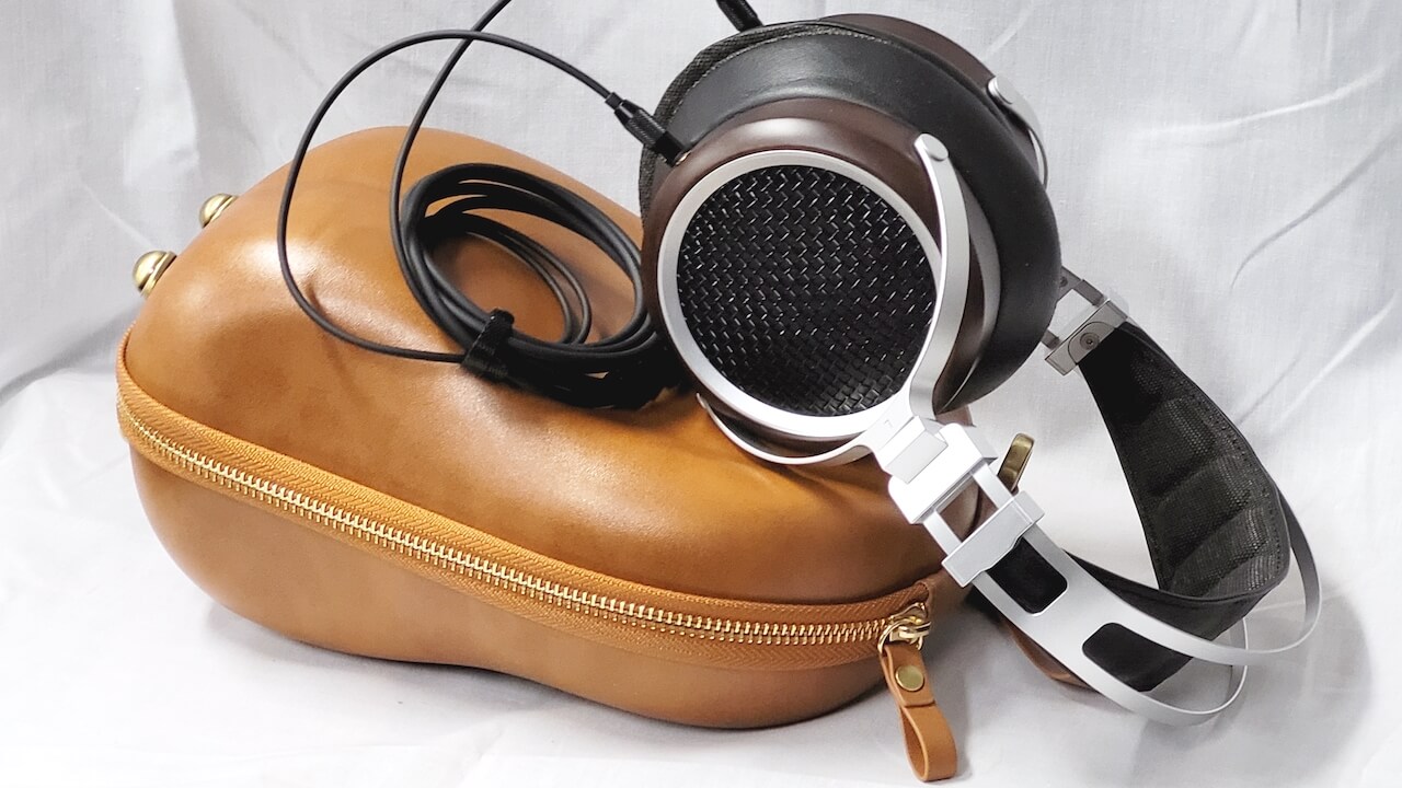 Sivga Luan Open-Back Headphones leaning on travel case